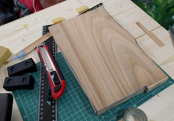 Step two for making a DIY carbon fiber pochade box.
