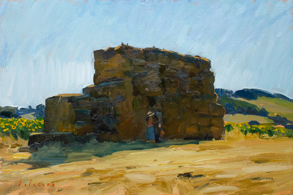 Plein air oil painting of an artist painting in the shade of haybales.